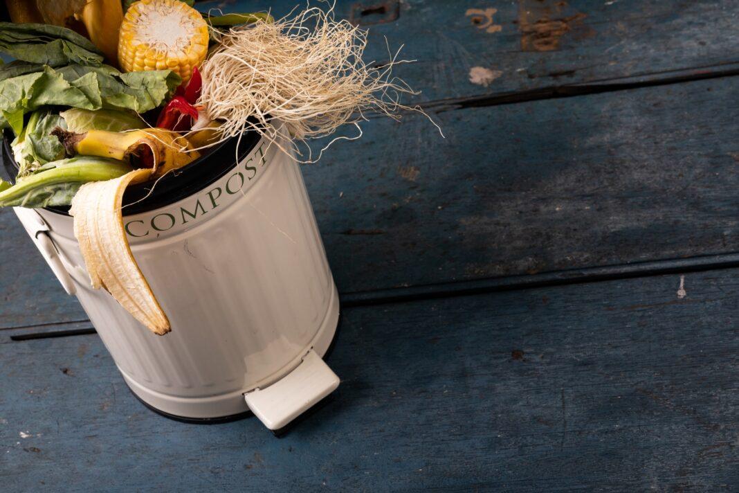 High angle view of organic rubbish in compost bin on wooden table