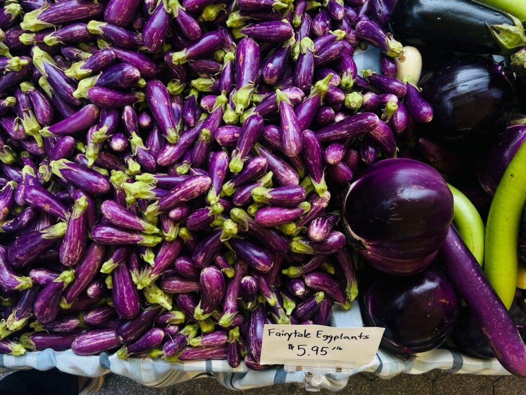 A vibrant display of fairytale eggplants for sale at a local market.