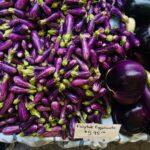 A vibrant display of fairytale eggplants for sale at a local market.