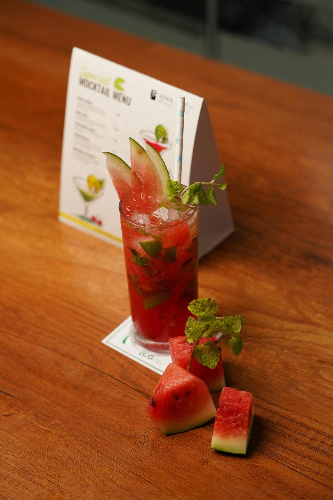 A vibrant watermelon cocktail garnished with mint leaves, perfect for summer refreshment.