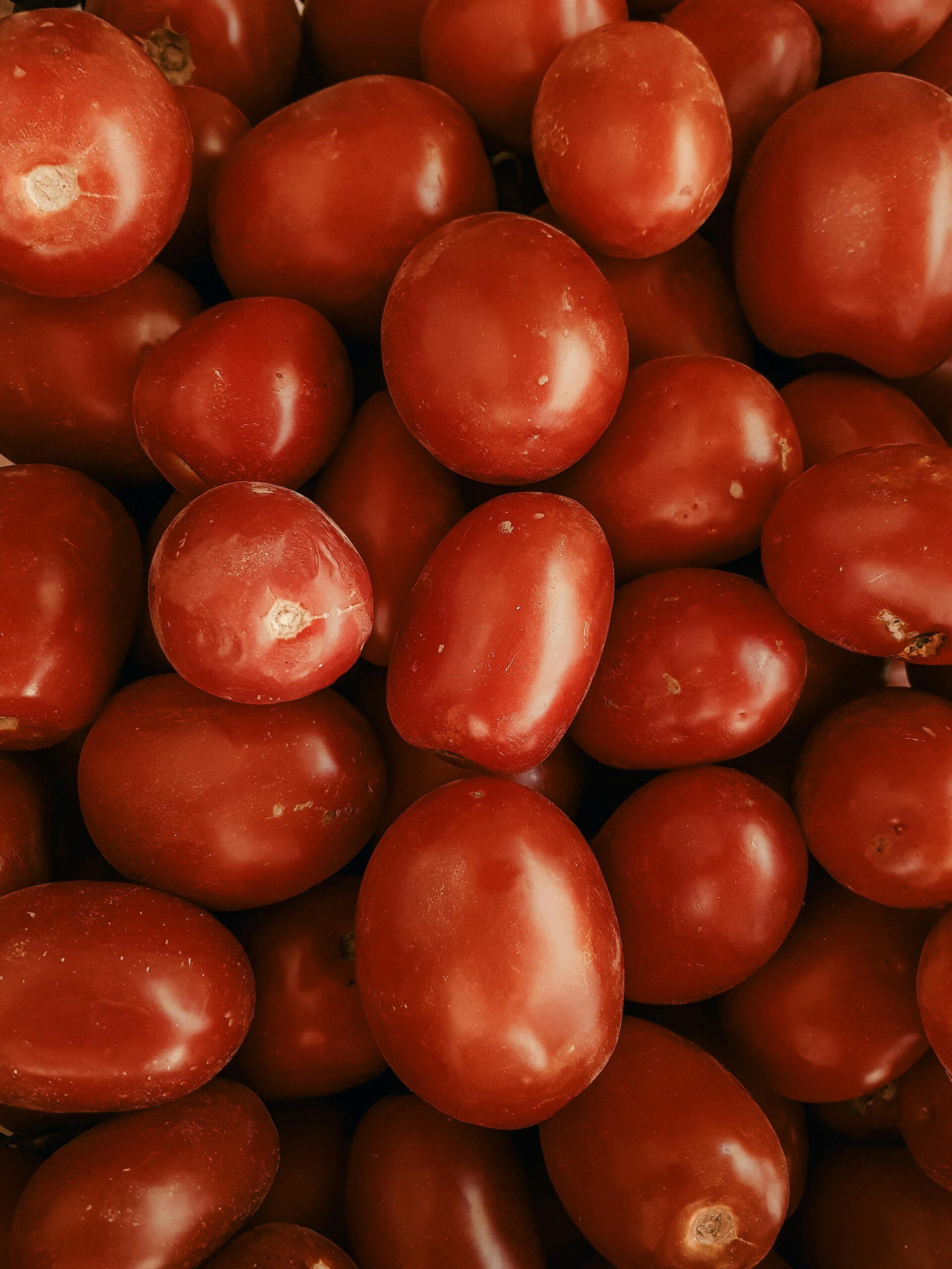 Vibrant red grape tomatoes close-up, highlighting freshness and abundance for food-oriented visuals.
