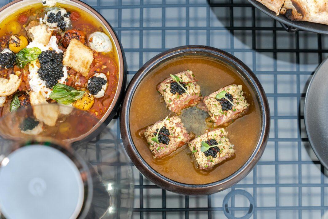 Overhead view of elegant caviar dishes in stylish bowls, showcasing modern dining aesthetics.