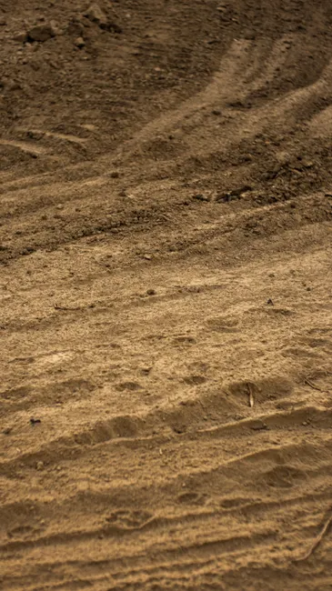 Full frame of abstract background of dry sandy ground in rural terrain in daylight