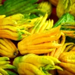 Vivid yellow and green Buddha's Hand citron fruits displayed in abundance.